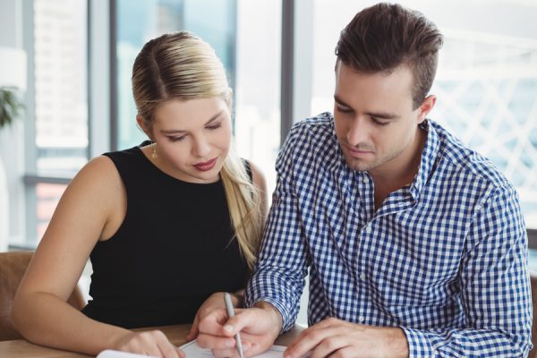 executives-discussing-over-paper-at-desk-2021-08-28-16-45-12-utc